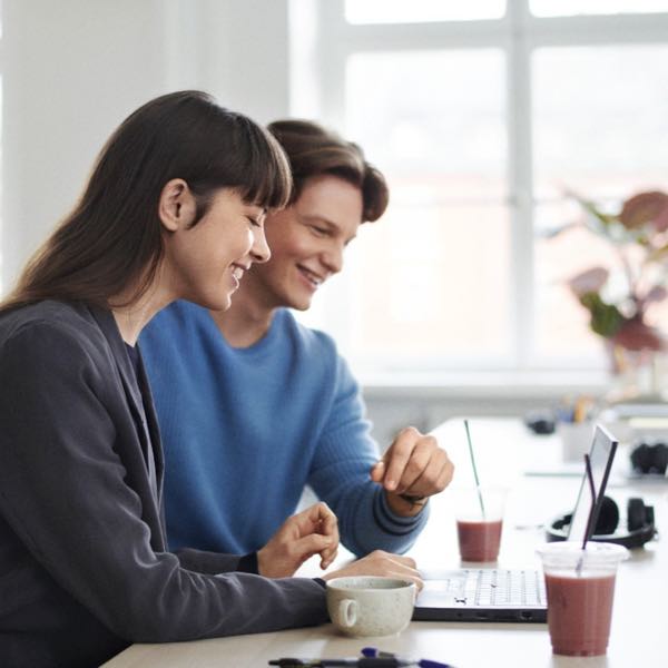 Two work colleagues in front of a computer screen.